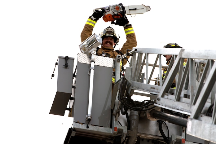 Chaz Cools, a firefighter from the 628th Civil Engineer Squadron, wields a chainsaw and poses for a picture, at Joint Base Charleston, S.C., Dec. 3, 2020. Swift and his team members at the 628th CES Fire Department support the mission by saving lives and protecting the people of Joint Base Charleston.