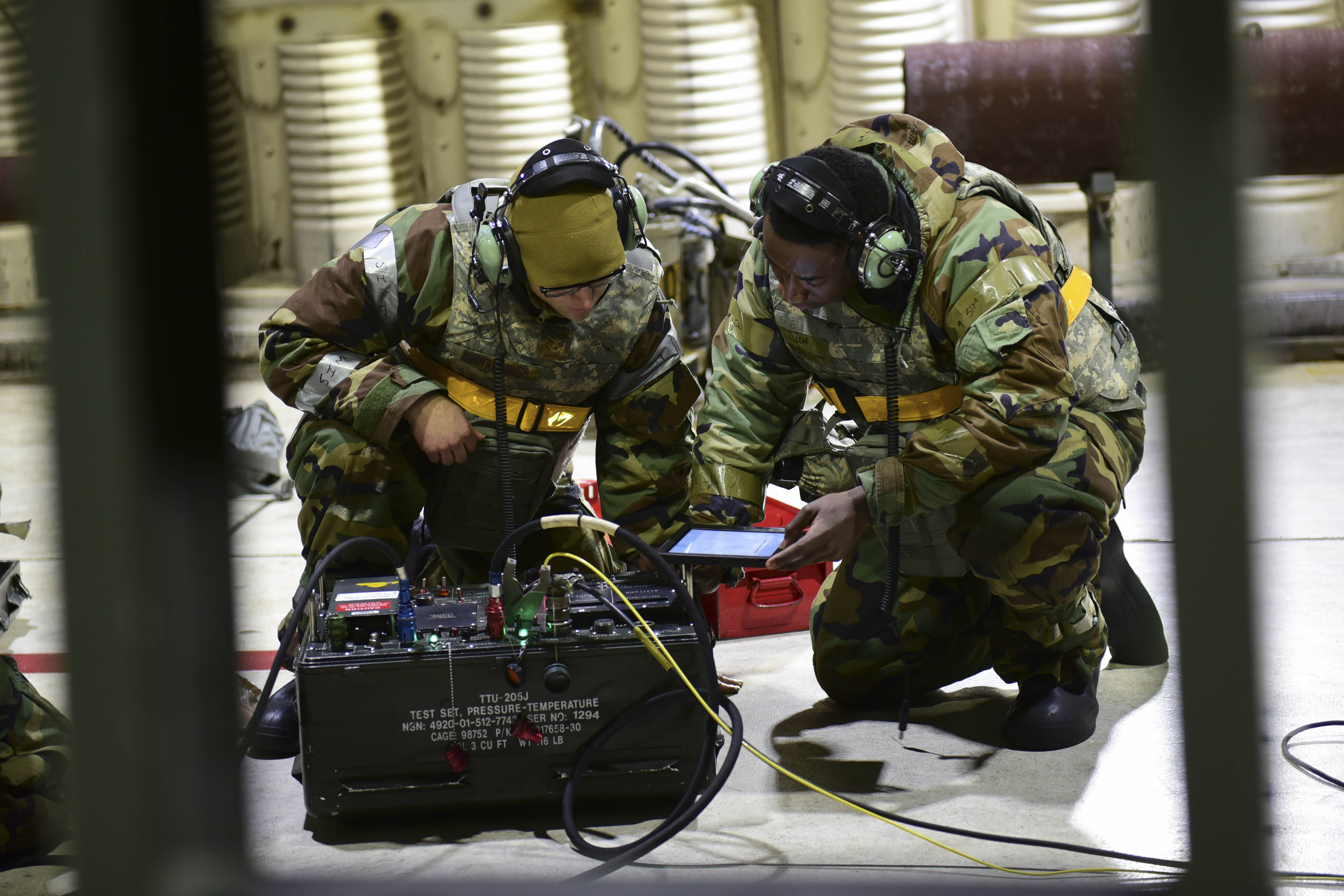 Senior Airman Joshua Foley And Airman 1st Class Waiting For Name 80th Aircraft Maintenance Unit Avionics Technicians Read A Technical Order For A Pressure Temperature Test Set On Kunsan Air Base Republic Of Korea Dec 8 Avionics
