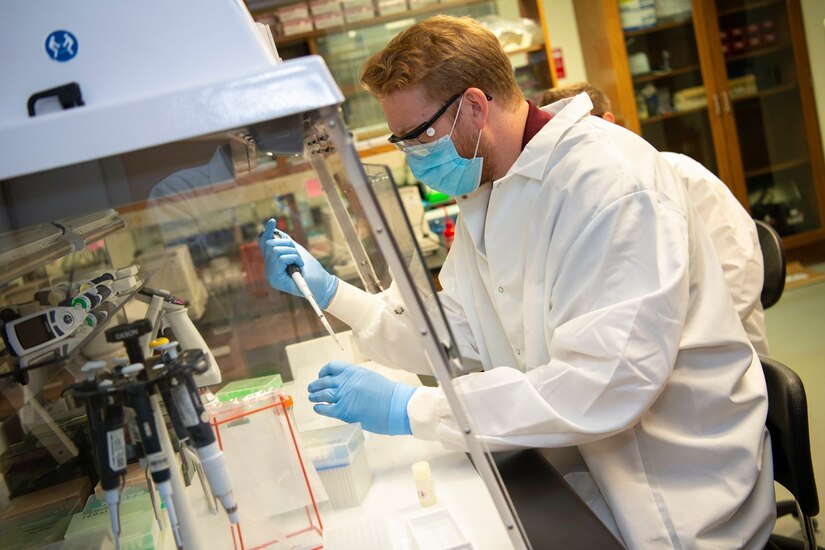 A man sitting in a lab.