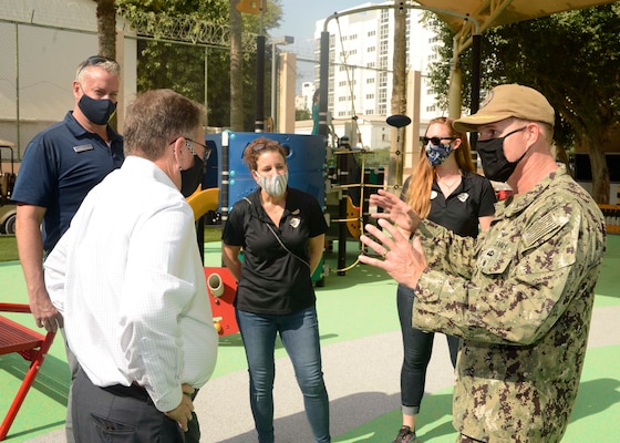 Assistant Secretary of the Navy (Energy, Installations and Environment) Charles Williams, Jr., speaks with Capt. Greg Smith, commanding officer, Naval Support Activity (NSA) Bahrain, Donald Wells, director of morale, welfare and recreation (MWR) Bahrain, and MWR personnel during a tour of Naval Support Activity (NSA) Bahrain.