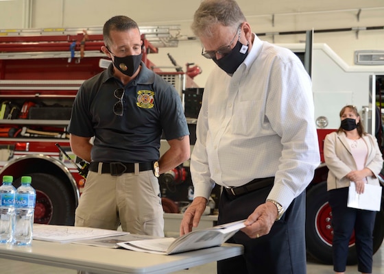 Assistant Secretary of the Navy (Energy, Installations and Environment) Charles Williams, Jr., reviews a planning document with Shannon Orndorff, Naval Support Activity (NSA) Bahrain's fire chief, during a tour of NSA Bahrain.