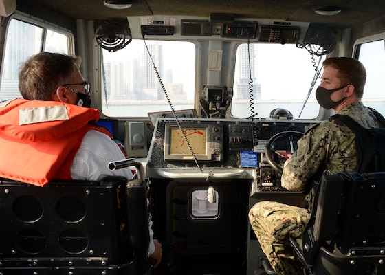 Assistant Secretary of the Navy (Energy, Installations and Environment) Charles Williams, Jr., speaks with Master-at-Arms 1st Class Jason Grooms while touring a harbor security boat during a tour of Naval Support Activity (NSA) Bahrain.