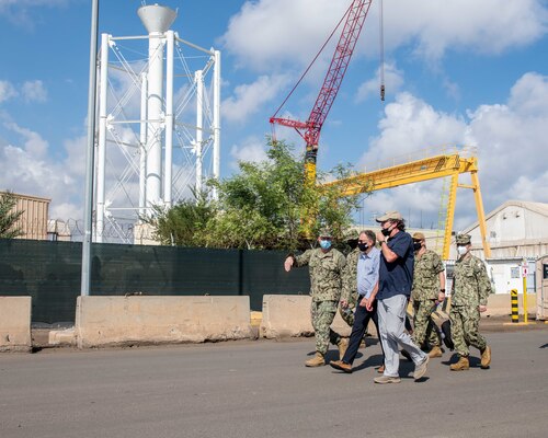 Cmdr. Kory Anglesey, left, Public Works Officer, Camp Lemonnier, Djibouti (CLDJ), speaks with Assistant Secretary of the Navy for Energy, Installations and Environment Charles Williams Jr. during a tour of facilities on base.