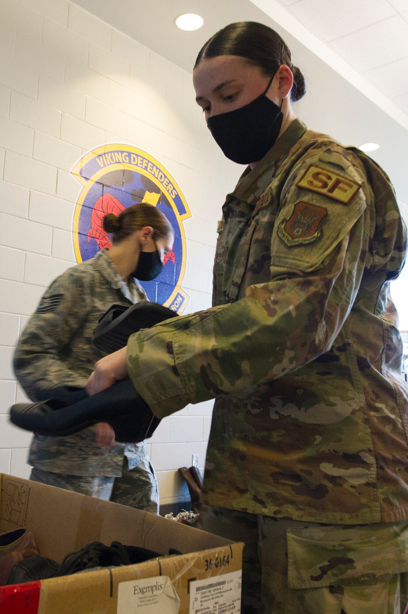 Airmen Sarah Corbett, 934th Security Forces fire team member, sorts and boxes up donated shoes from a donation drive during November unit training assembly at Minneapolis-St. Paul Air Reserve Station, November 18, 2020. (U.S. Air Force photo by Chris Farley)