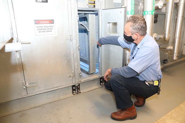 Randy Beghtel, a machinery maintenance mechanic, checks an air-handling unit at the Zorinsky federal building in Omaha, Neb., Oct. 30, 2020.