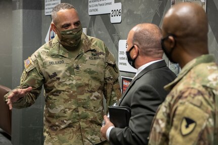 Command Sgt. Maj. Alberto Delgado, U.S. Army Materiel Command senior enlisted advisor, talks with Barry Hoffman, U.S. Army Financial Management Command deputy to the commanding general, and Command Sgt. Maj. Kenneth F. Law, USAFMCOM senior enlisted advisor, at the Maj. Gen. Emmett J. Bean Federal Center in Indianapolis Nov. 20, 2020. Delgado joined Gen. Edward Daly, AMC commanding general, on their first visit to USAFMCOM. (U.S. Army photo by Mark R. W. Orders-Woempner)