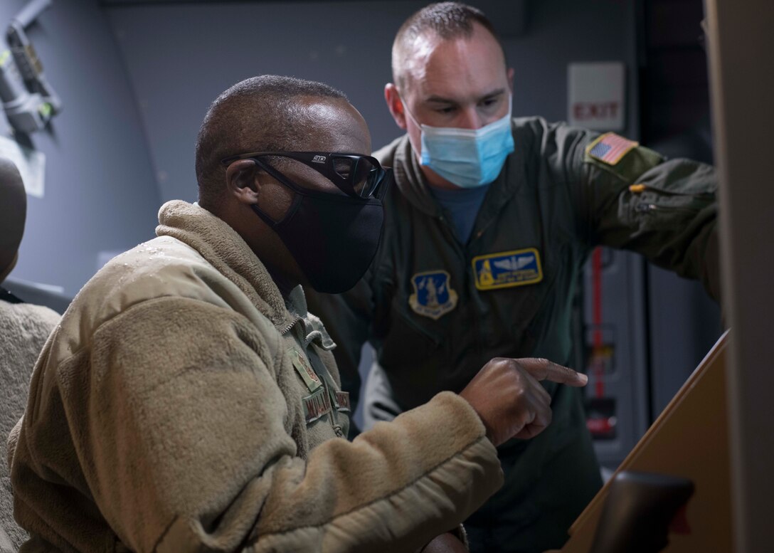 U.S. Air Force Chief Master Sgt. Maurice L. Williams, command chief, Air National Guard (ANG), listens to Master Sgt. Brett Peterson, a boom operator assigned to the 133d Air Refueling Squadron, 157th Air Refueling Wing (ARW), explain KC-46 Pegasus refueling operations during a visit to Pease Air National Guard Base, Portsmouth, New Hampshire, Dec. 5, 2020. As the first ANG unit to receive the KC-46, Williams and Lt. Gen. Michael A. Loh, ANG director, visited the 157th ARW to speak with Airmen and hear their experiences working with the new airframe. (U.S. Air National Guard photo by Tech. Sgt. Morgan R. Lipinski)