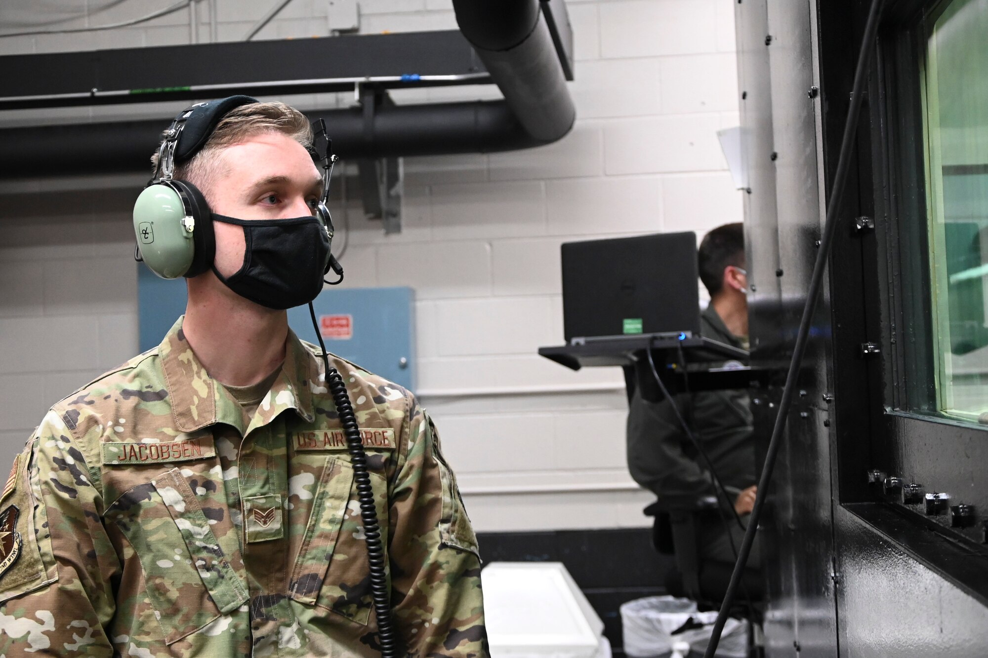 U.S. Air Force Senior Airman Jake Jacobsen, 14th Flying Training Wing public affairs specialist, observes pilots undergoing hypobaric chamber training Dec.7, 2020, on Columbus Air Force Base, Miss. Jacobsen participated in a job swap program, which gives Airmen from around the base a chance to see what other units do to ensure the mission runs smoothly. (U.S. Air Force photo by Airman 1st Class Jessica Williams)