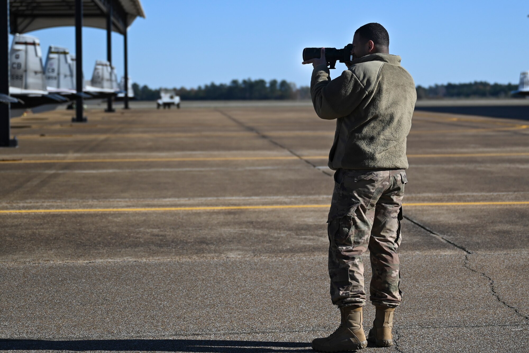 U.S. Air Force Senior Airman David Richardson, 14th Operations Support squadron aircrew flight equipment technician, practices photographing aircraft during a job swap with Public Affairs Nov. 11, 2020, on Columbus Air Force Base, Miss. Air Force Public Affairs advances Air Force priorities and achieves mission objectives through integrated planning, execution, and assessment of communication capabilities. (U.S. Air Force photo by Airman 1st Class Jessica Williams)