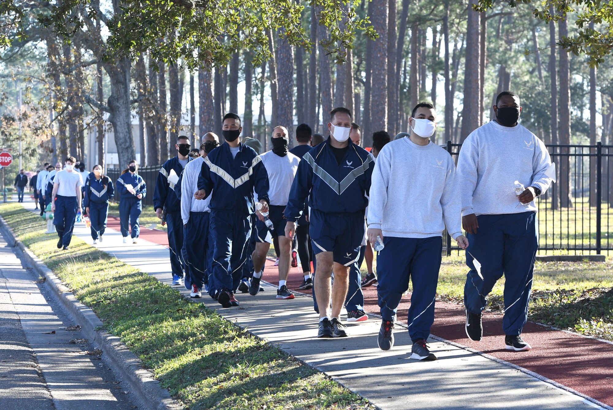 Members of the 338th Training Squadron participate in the Dragon March at Keesler Air Force Base, Mississippi, Dec. 8, 2020. The theme of the three-mile walk was "Stronger Together." (U.S. Air Force photo by Kemberly Groue)