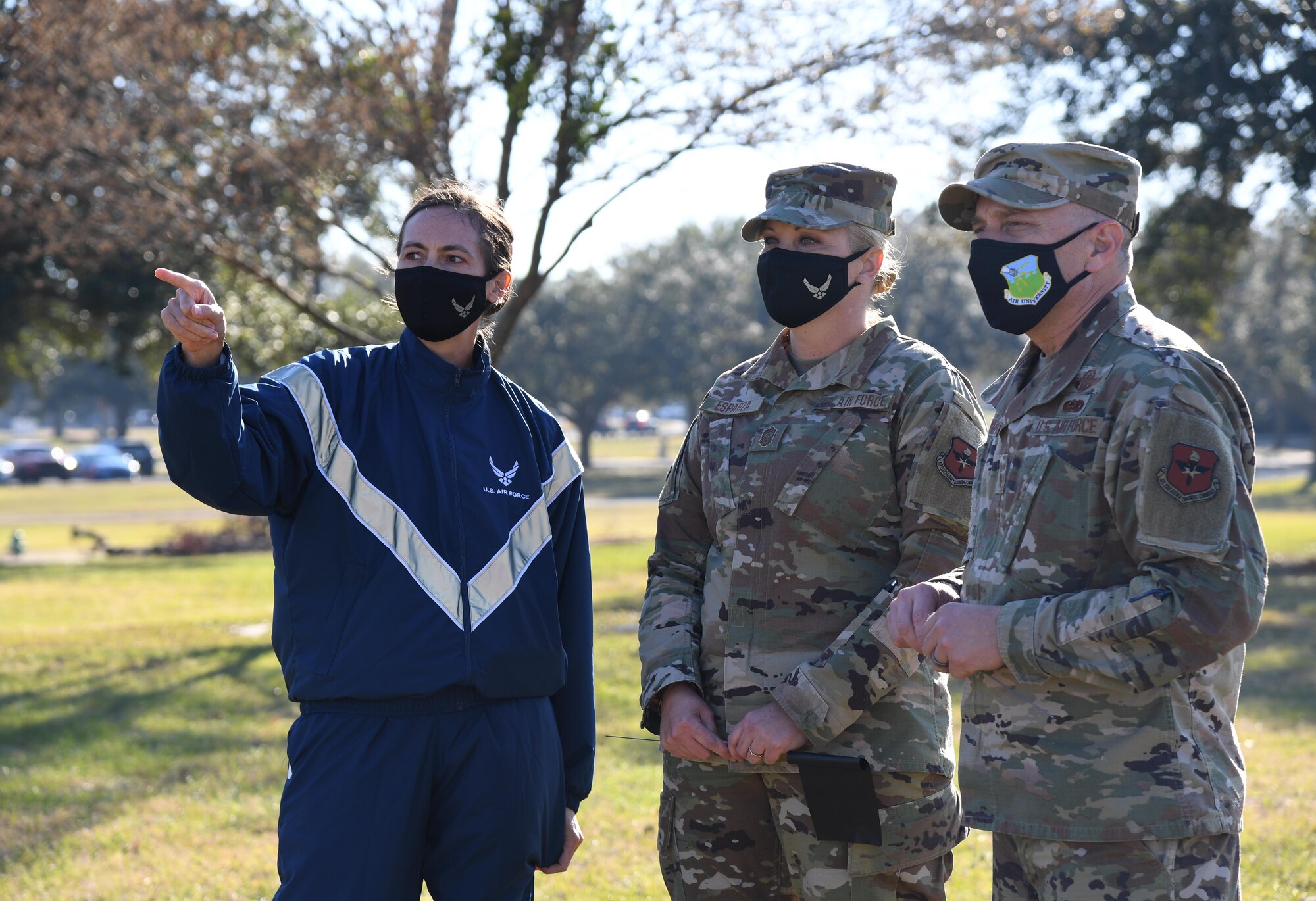 U.S. Air Force Col. Heather Blackwell, 81st Training Wing commander, points out the rally point to Chief Master Sgt. Sarah Esparza, 81st TRW command chief, and Chief Master Sgt. Erik Thompson, command chief of Air Education and Training Command, at Heritage Field during the Dragon March at Keesler Air Force Base, Mississippi, Dec. 8, 2020. The theme of the three-mile walk was "Stronger Together." (U.S. Air Force photo by Kemberly Groue)