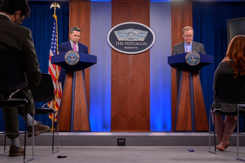 Two men brief reporters at the Pentagon.