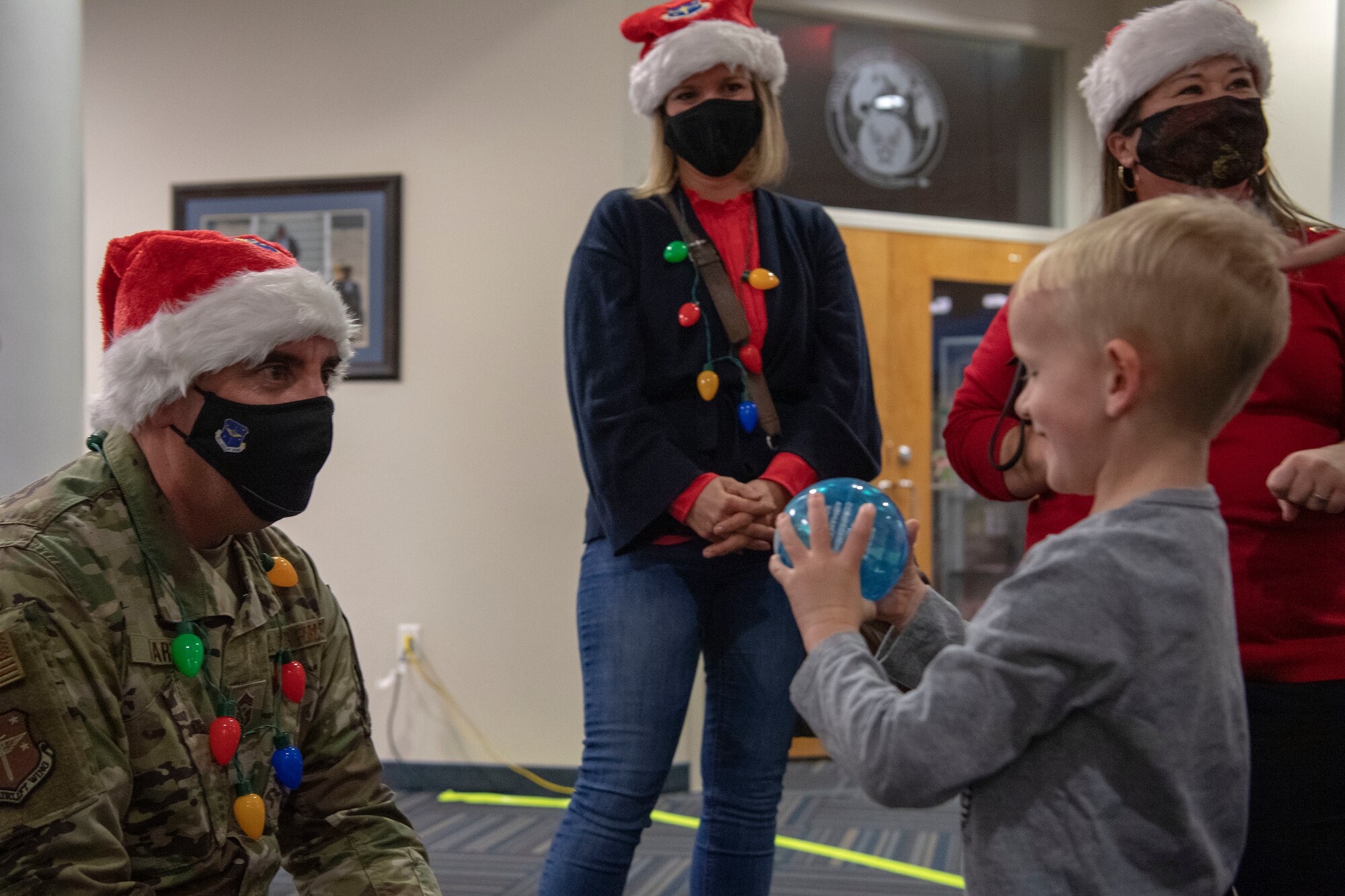 Chief Master Sgt. Steven Hart, 19th Airlift Wing command chief, speaks with a child during a Deployed Family Dinner.