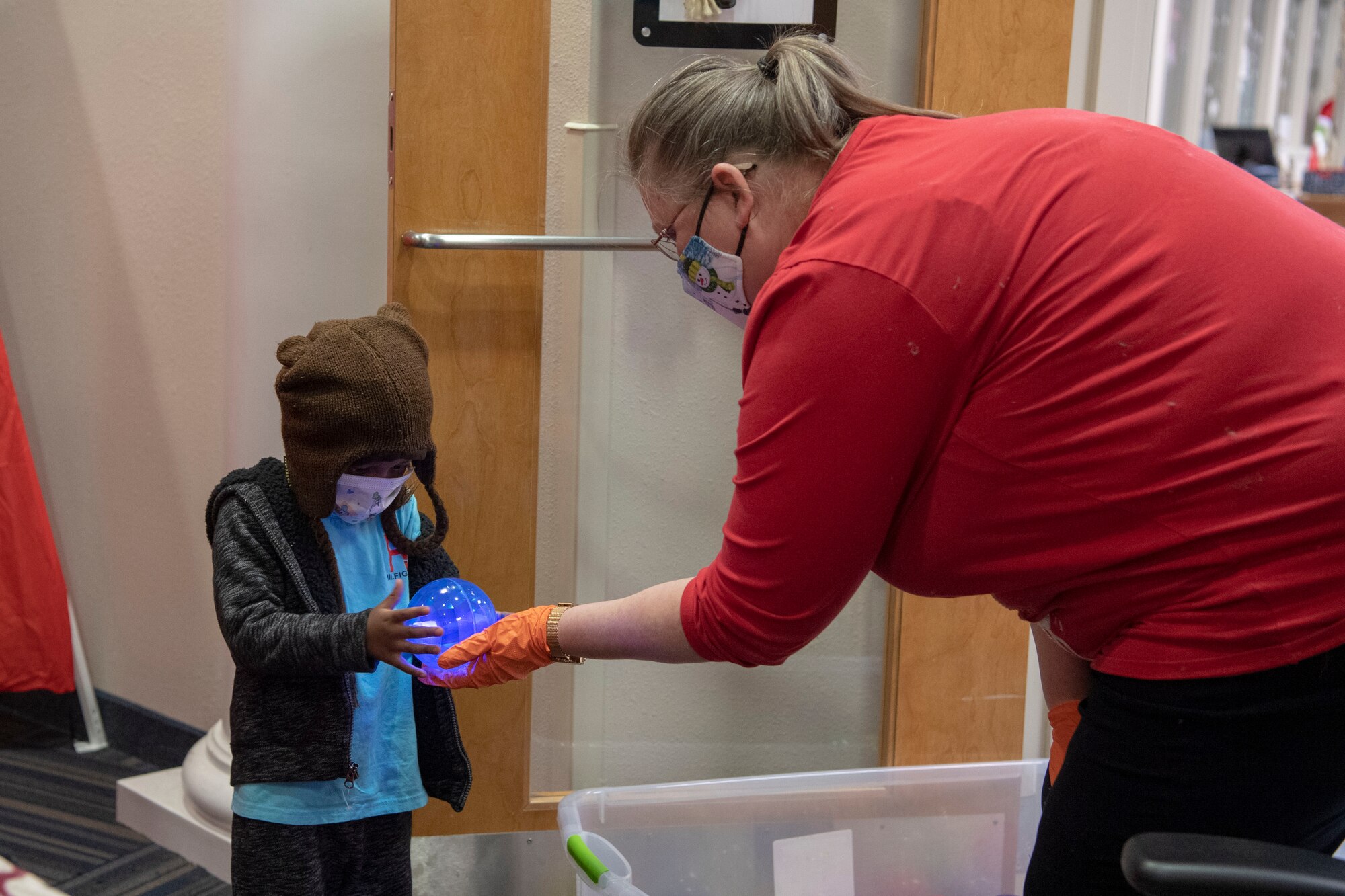 A member from the AFRC speaks with a child during a deployed family dinner.