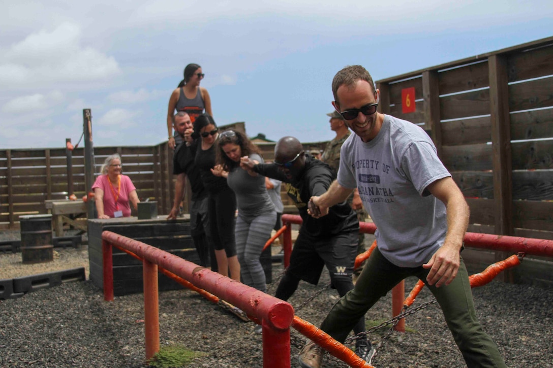 Educators from San Diego participate in one of the obstacles during the Leadership Reaction Course as part of the Educators Workshop at Marine Corps Base Camp Pendleton, California, June 20, 2019. The mission of the Educators Workshop is to inform, demonstrate and build relationships while providing educators and community influencers with firsthand knowledge of the Marine Corps recruiting process, entry level training, job opportunities and educational benefits available to Marines. (U.S. Marine Corps photo by Sgt. Bernadette Plouffe)