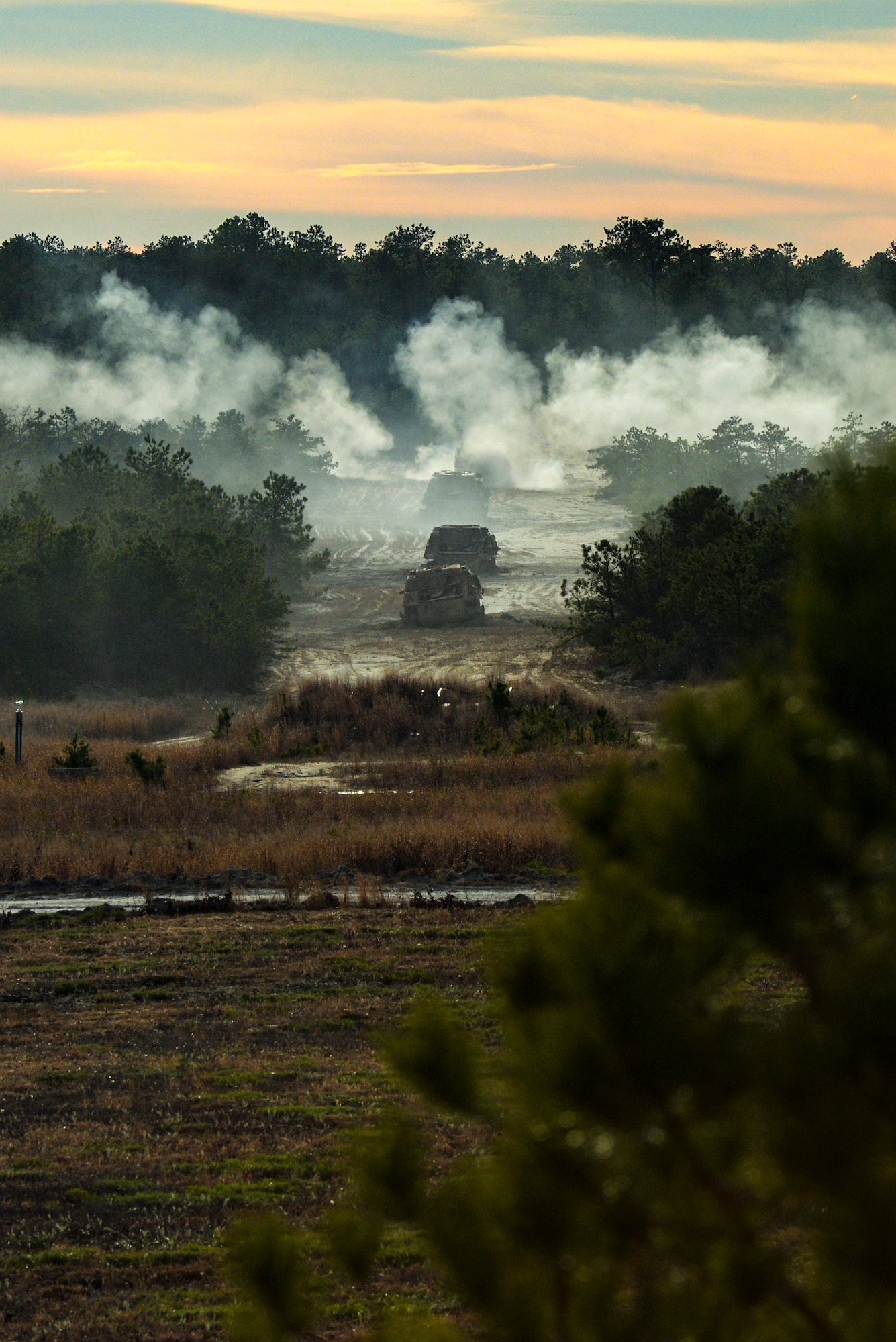 A photo of a line of unserviceable demilitarized tanks being used as targets for training.