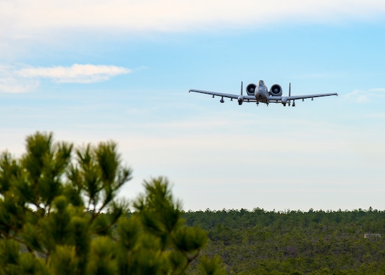 A photo of an A-10 Thunderbolt II flying over the Warren Grove Gunnery Range