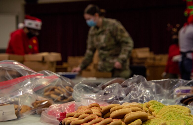 Volunteers box up donated cookies for dorm resident Airmen during Operation Cookie Drop Dec. 9, 2020, at Joint Base Lewis-McChord, Wash. The operation received more than 1,000 dozen cookies, which exceeded the goal of 700 dozen cookies for dorm resident Airmen. (U.S. Air Force photo by Senior Airman Tryphena Mayhugh)