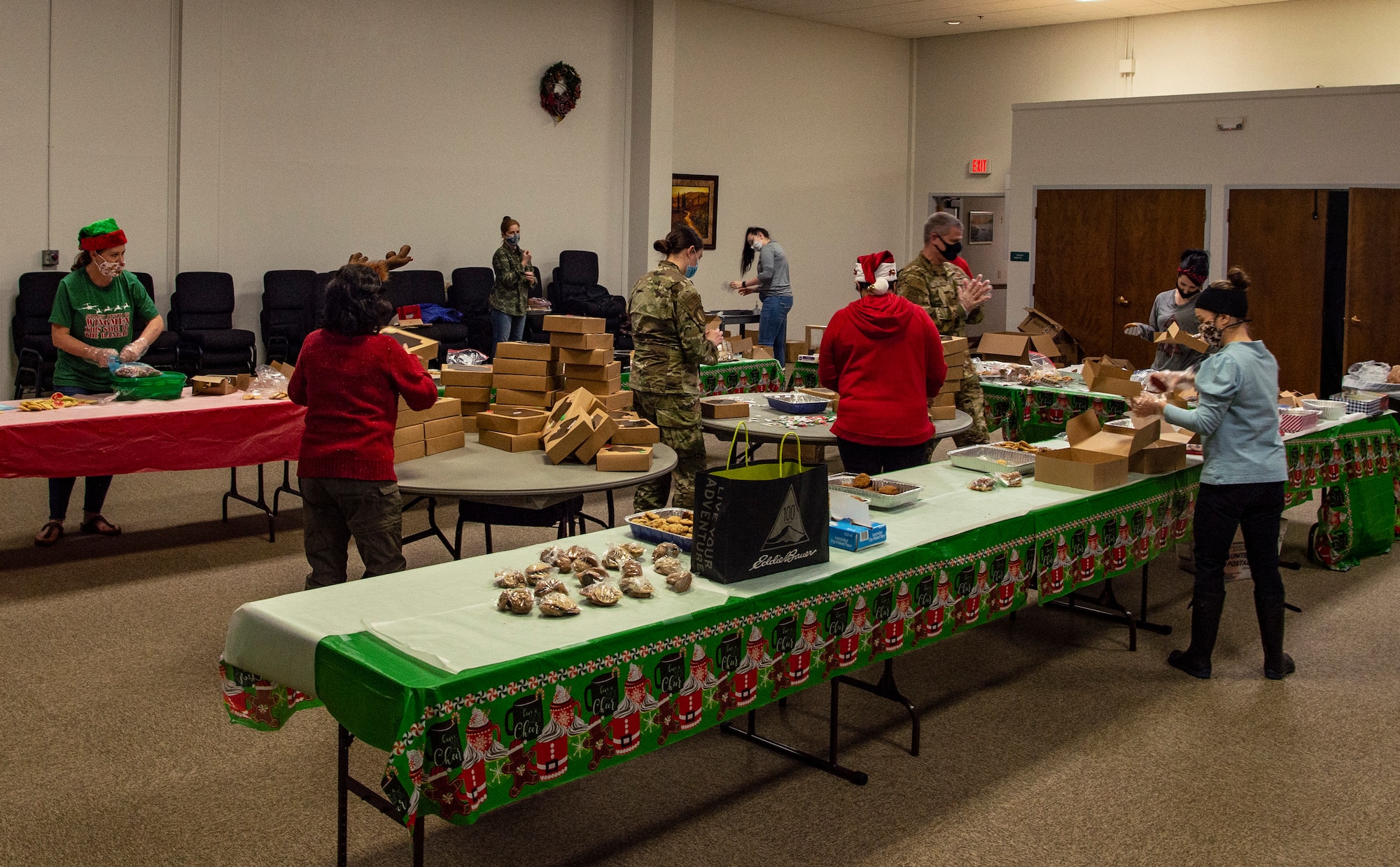 Volunteers box up dozens of cookies during Operation Cookie Drop Dec. 9, 2020, at Joint Base Lewis-McChord, Wash. Operation Cookie Drop delivers donated cookies to dorm resident Airmen for the holidays. (U.S. Air Force photo by Senior Airman Tryphena Mayhugh)