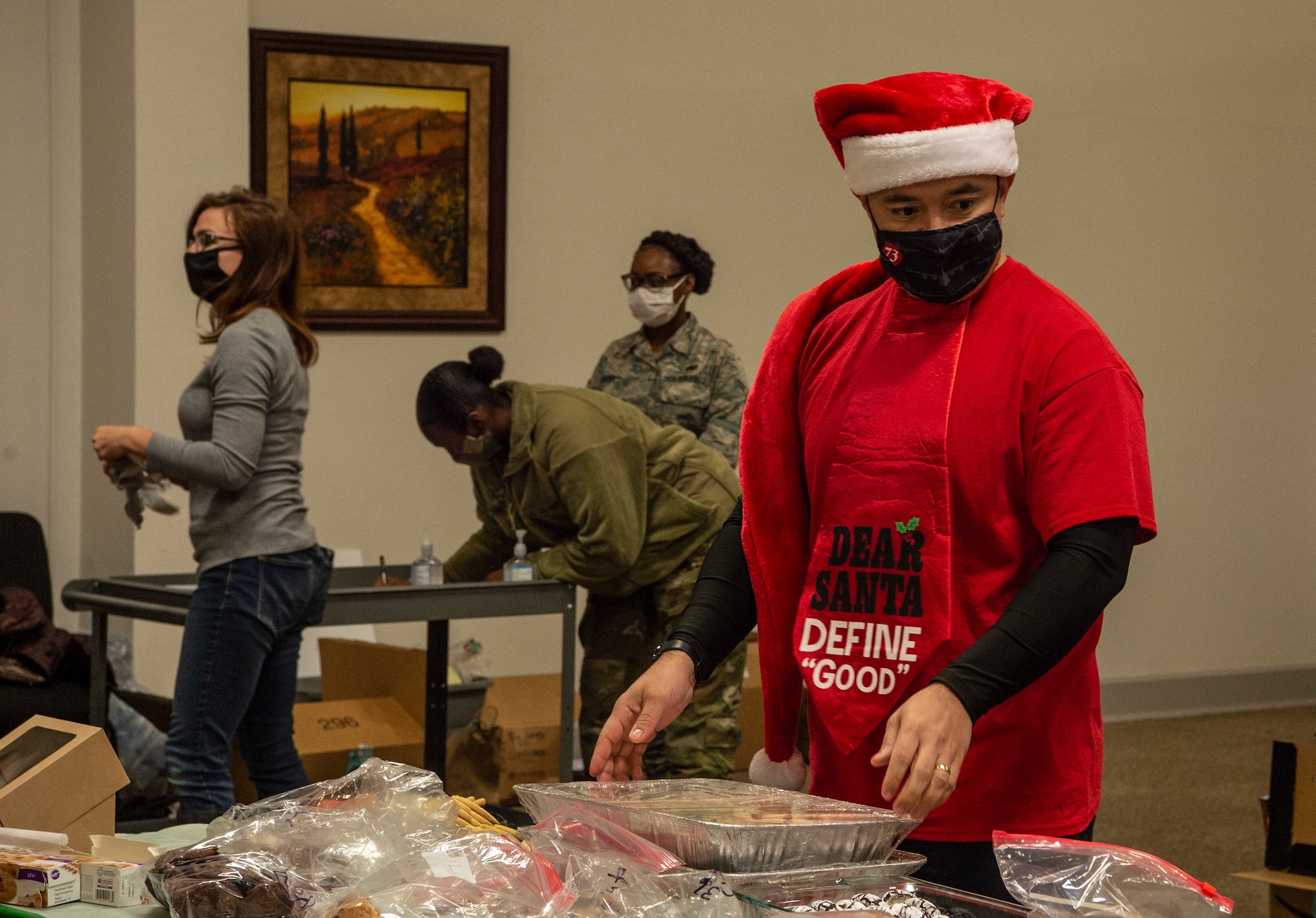 Chief Master Sgt. Joseph Arce, 62nd Airlift Wing command chief, sets down donated cookies during Operation Cookie Drop Dec. 9, 2020, at Joint Base Lewis-McChord, Wash. The operation received more than 1,000 dozen cookies, which exceeded the goal of 700 dozen cookies for dorm resident Airmen.   (U.S. Air Force photo by Senior Airman Tryphena Mayhugh)