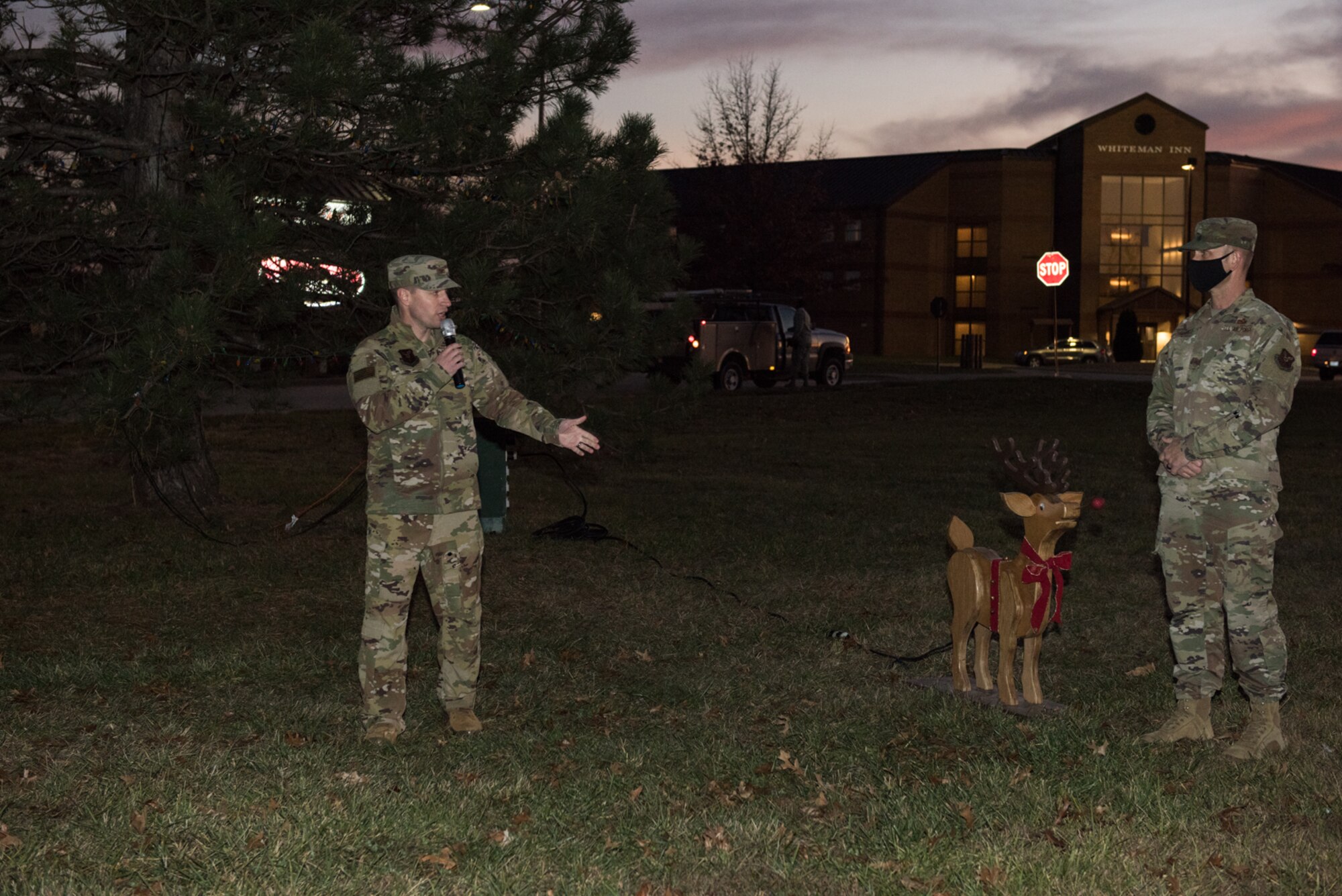 U.S. Air Force Col. Kyle Wilson, 509th Bomb Wing vice commander, speaks during the annual Christmas Tree Lighting Ceremony with U.S. Air Force Chief Master Sgt. Jason Hodges, 509th Bomb Wing command chief, at Whiteman Air Force Base, Missouri, Dec. 8, 2020. Wilson addressed attendees on the importance of giving back to Team Whiteman during this year and the coronavirus pandemic. (U.S. Air Force photo by Airman 1st Class Christina Carter)