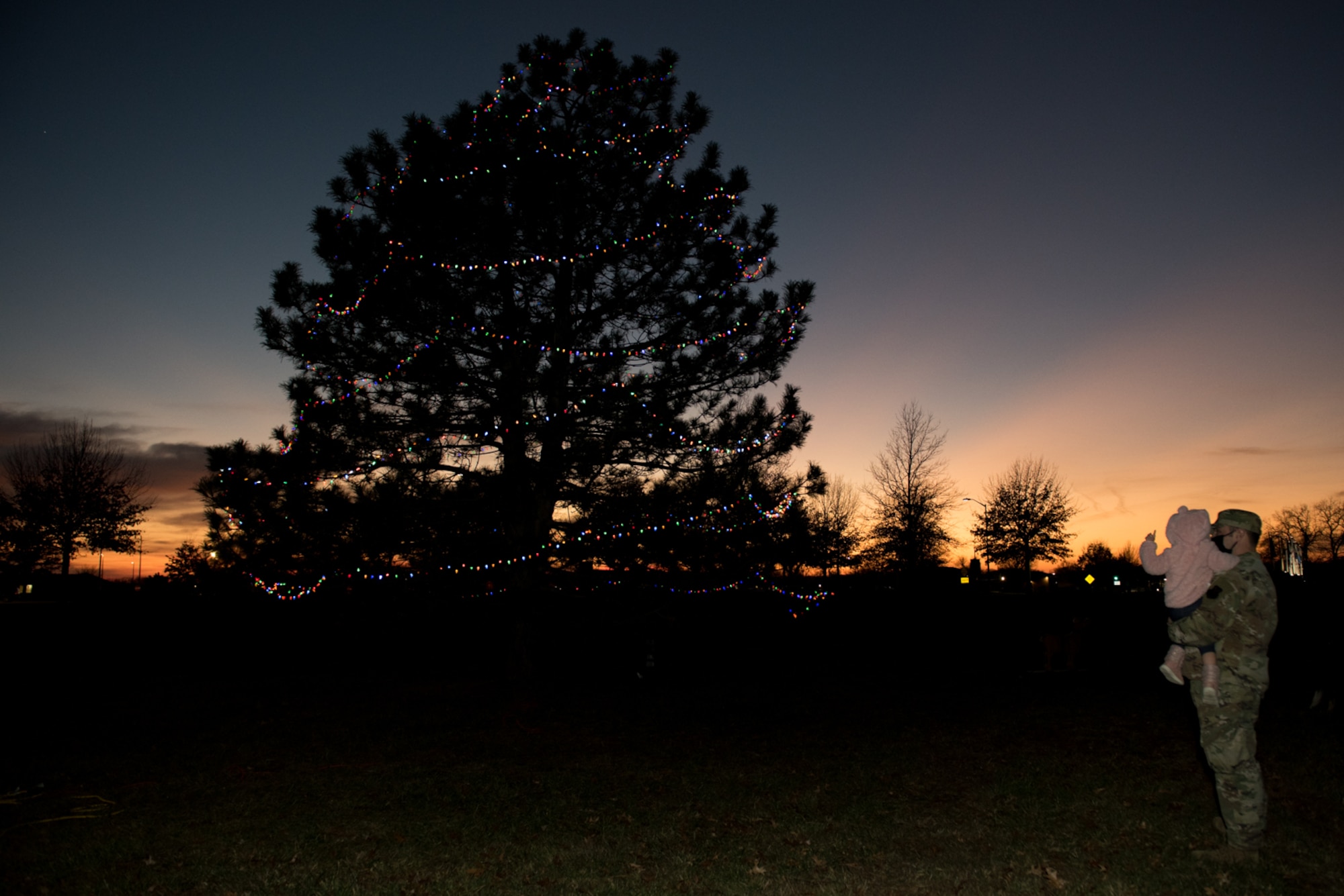 Members of Team Whiteman attended the annual Christmas Tree Lighting Ceremony at Whiteman Air Force Base, Missouri, Dec. 8, 2020. During the event, families watched the tree lighting, met with Santa Claus, went ice skating and took home crafts and cookies. Participants continued to wear masks and safely distance from each other in adherence to the COVID-19 restrictions. (U.S. Air Force photo by Airman 1st Class Christina Carter)