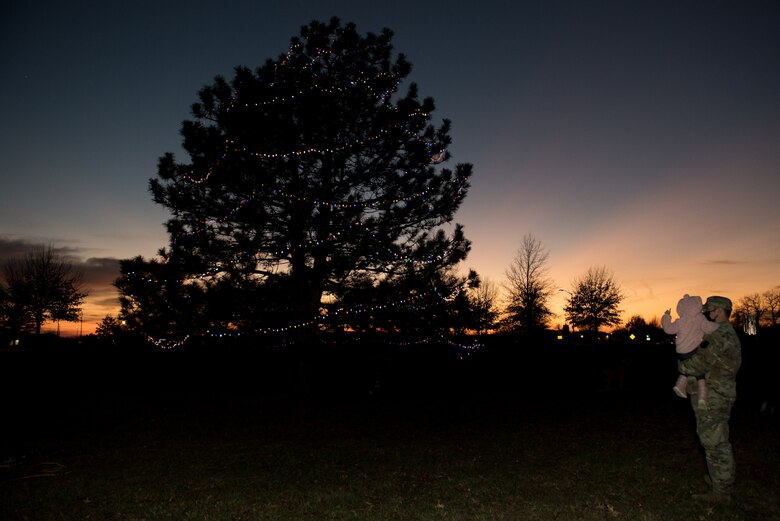 Members of Team Whiteman attended the annual Christmas Tree Lighting Ceremony at Whiteman Air Force Base, Missouri, Dec. 8, 2020. During the event, families watched the tree lighting, met with Santa Claus, went ice skating and took home crafts and cookies. Participants continued to wear masks and safely distance from each other in adherence to the COVID-19 restrictions. (U.S. Air Force photo by Airman 1st Class Christina Carter)