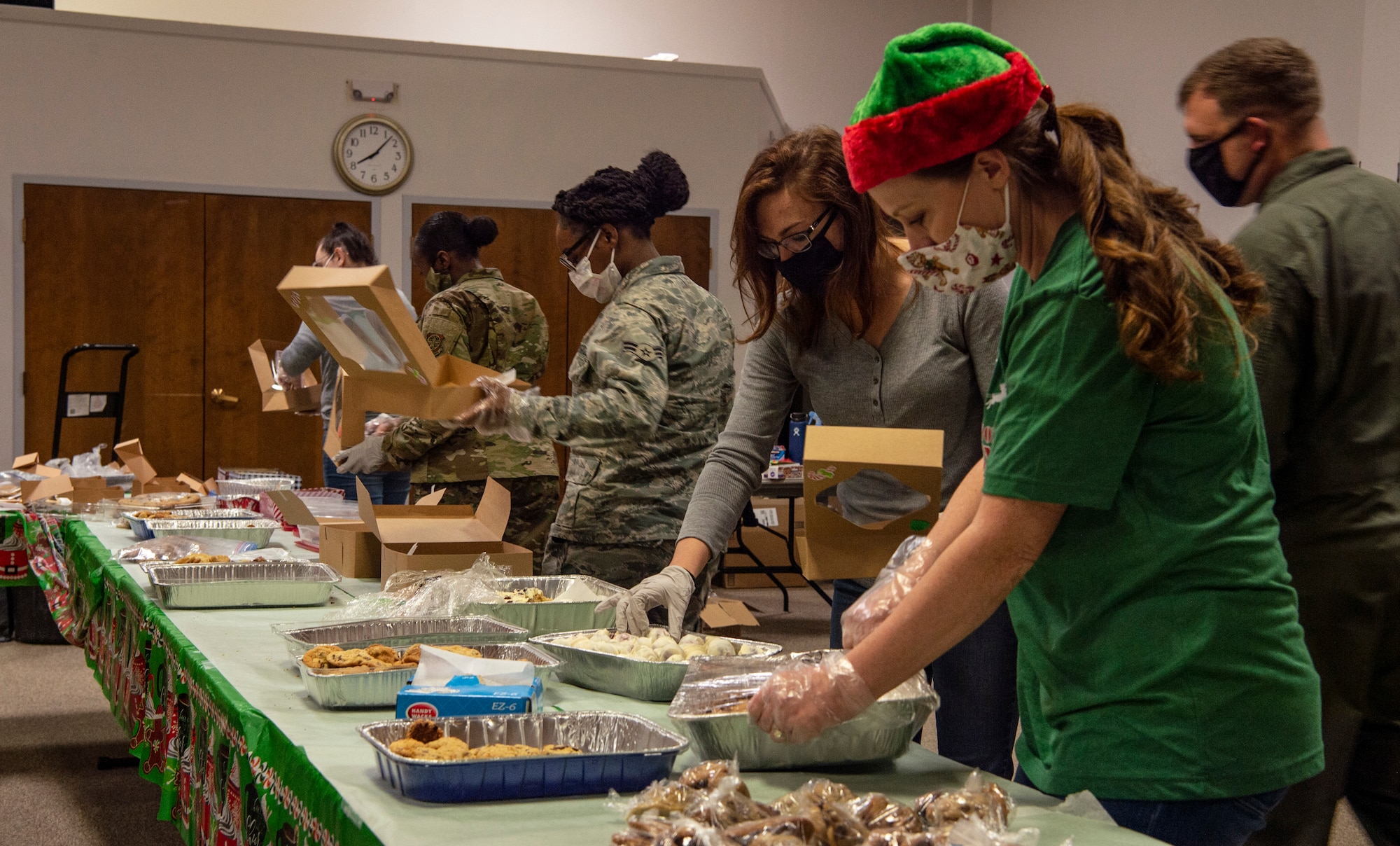 Volunteers box up cookies during Operation Cookie Drop Dec. 9, 2020, at Joint Base Lewis-McChord, Wash. The operation received more than 1,000 dozen cookies, which exceeded the goal of 700 dozen cookies for dorm resident Airmen. (U.S. Air Force photo by Senior Airman Tryphena Mayhugh)