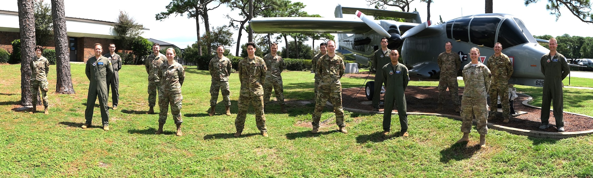 Photo of 16 U.S. Air Force Airmen standing in front of an aircraft.