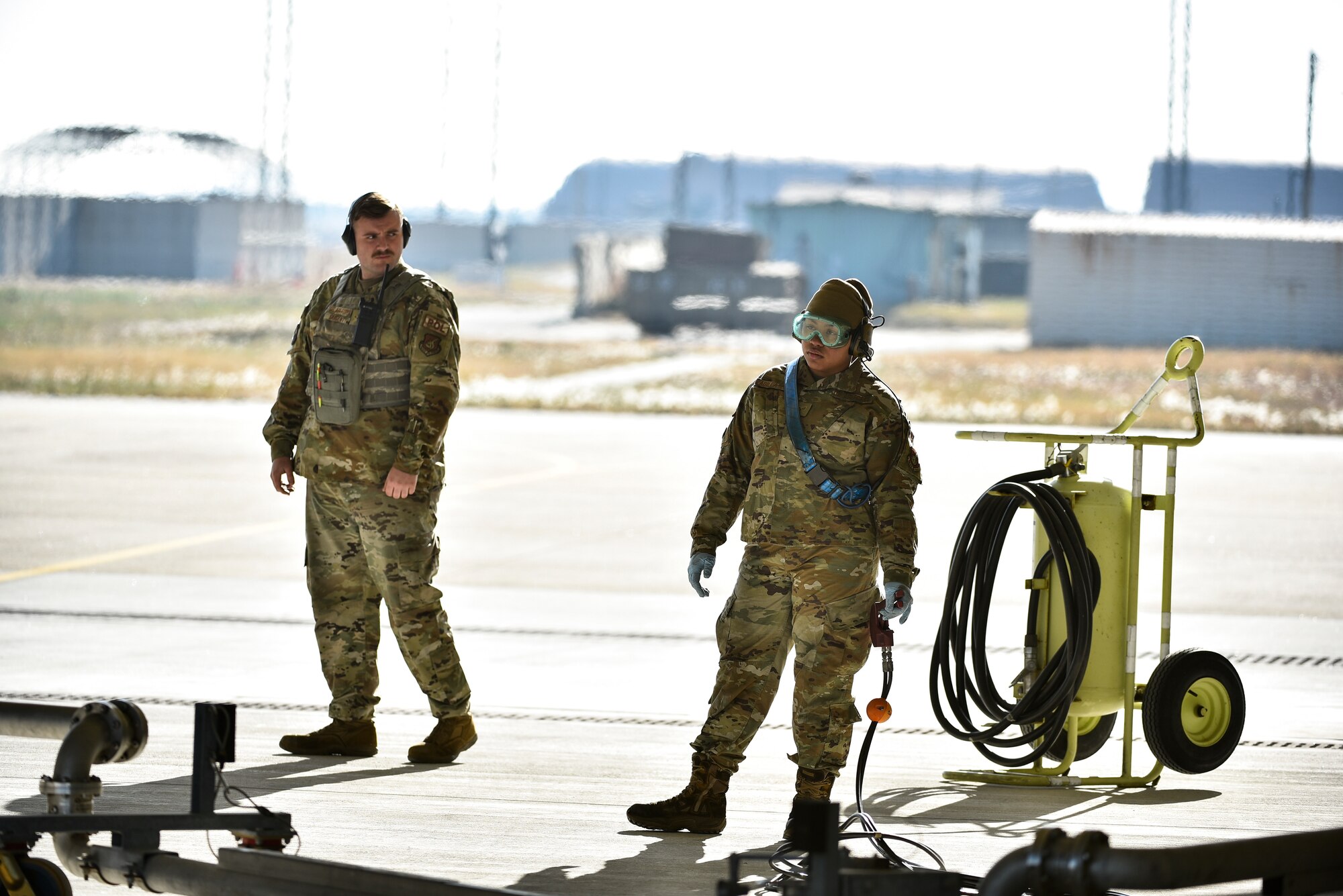 Airmen standby next to a fighter jet.