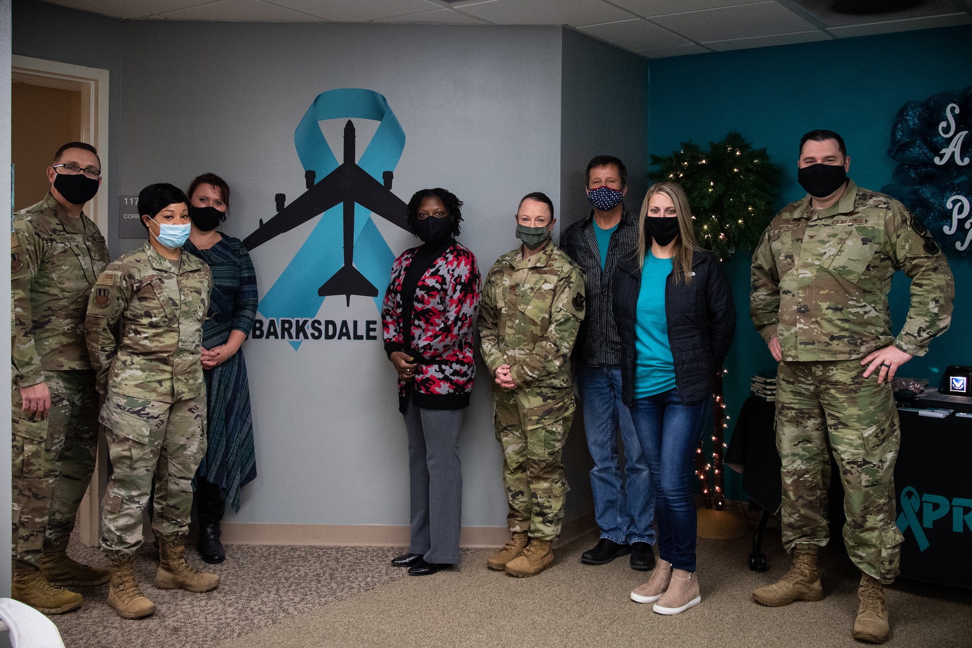 The Sexual Assault Prevention and Response (SAPR) team poses for a group photo with the 2nd Bomb Wing command team at Barksdale Air Force Base, La., Dec. 4, 2020.