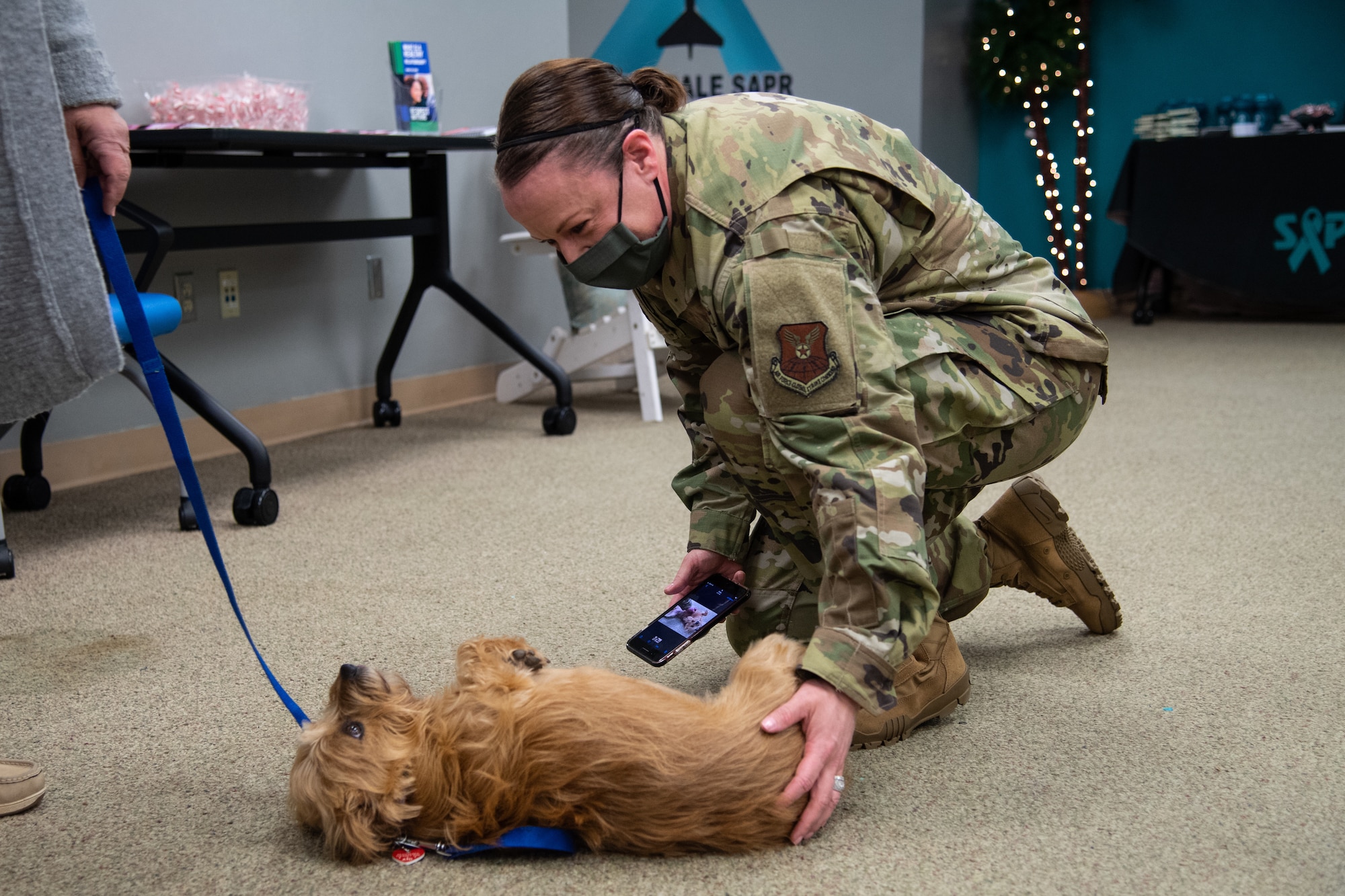 Maj. Minde Geiger, 2nd Bomb Wing deputy sexual assault response cooriantor, photographs a therapy dog at Barksdale Air Force Base, La., Dec. 4, 2020.
