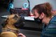 Misty Talley, sexual assault response coordinator, pets a therapy dog at Barksdale Air Force Base, La., Dec. 4, 2020.