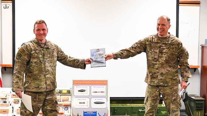 Master Sgt. Ian Garcia, left, 2nd Civil Engineer Squadron section chief explosive ordnance disposal logistics, poses for a photo with Col. Randy Whitecotton, right, 2nd Mission Support Group commander, at Barksdale Air Force Base, La., Dec. 1, 2020.
