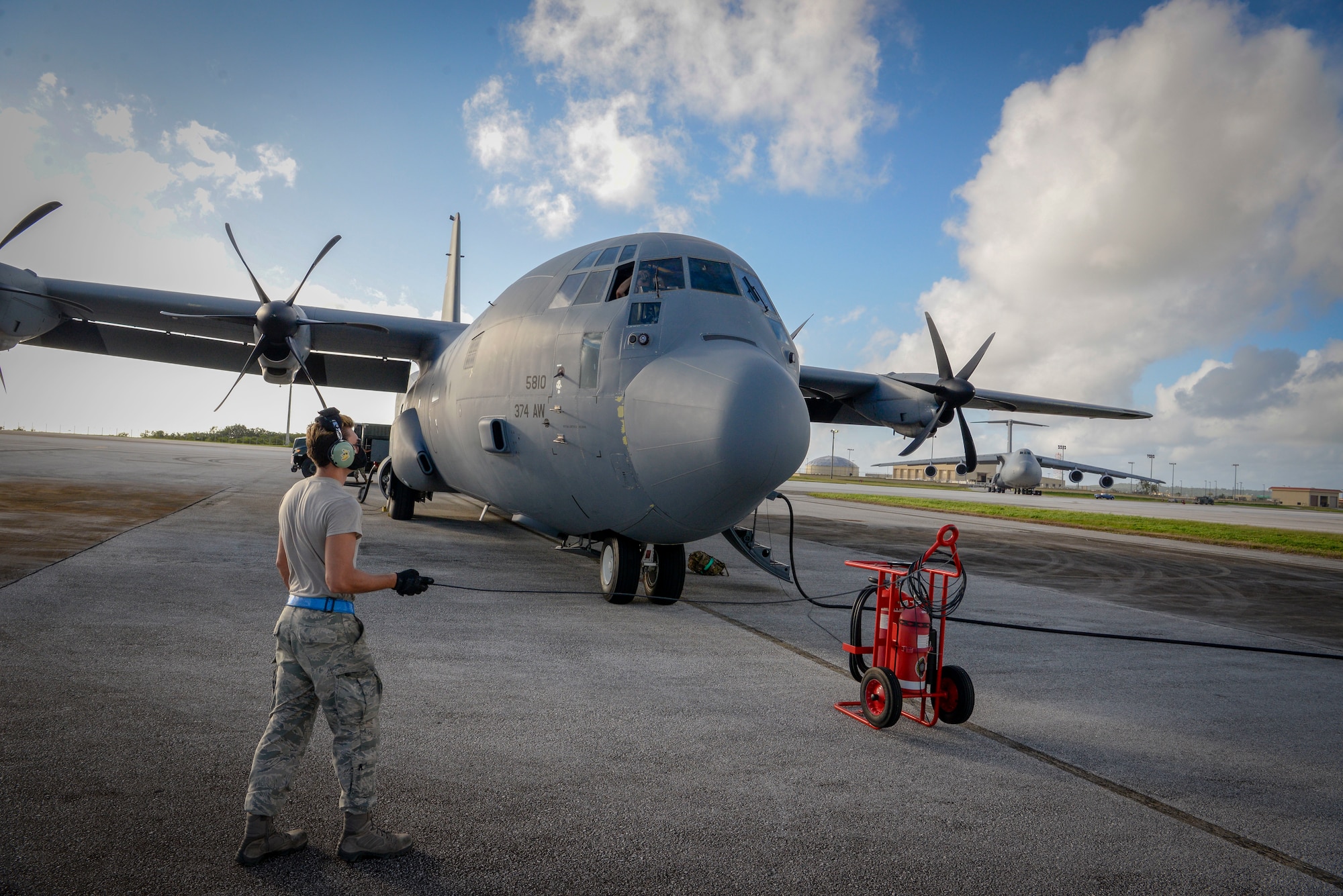 Senior Airman Stephen Yarbrough, 374th Aircraft Maintenance Squadron crew chief from Yokota Air Base, Japan, communicates with the rest of his team aboard a C-130J Super Hercules via radio during the refueling process at Operation Christmas Drop 2020 at Andersen Air Force Base, Guam, Dec. 9.