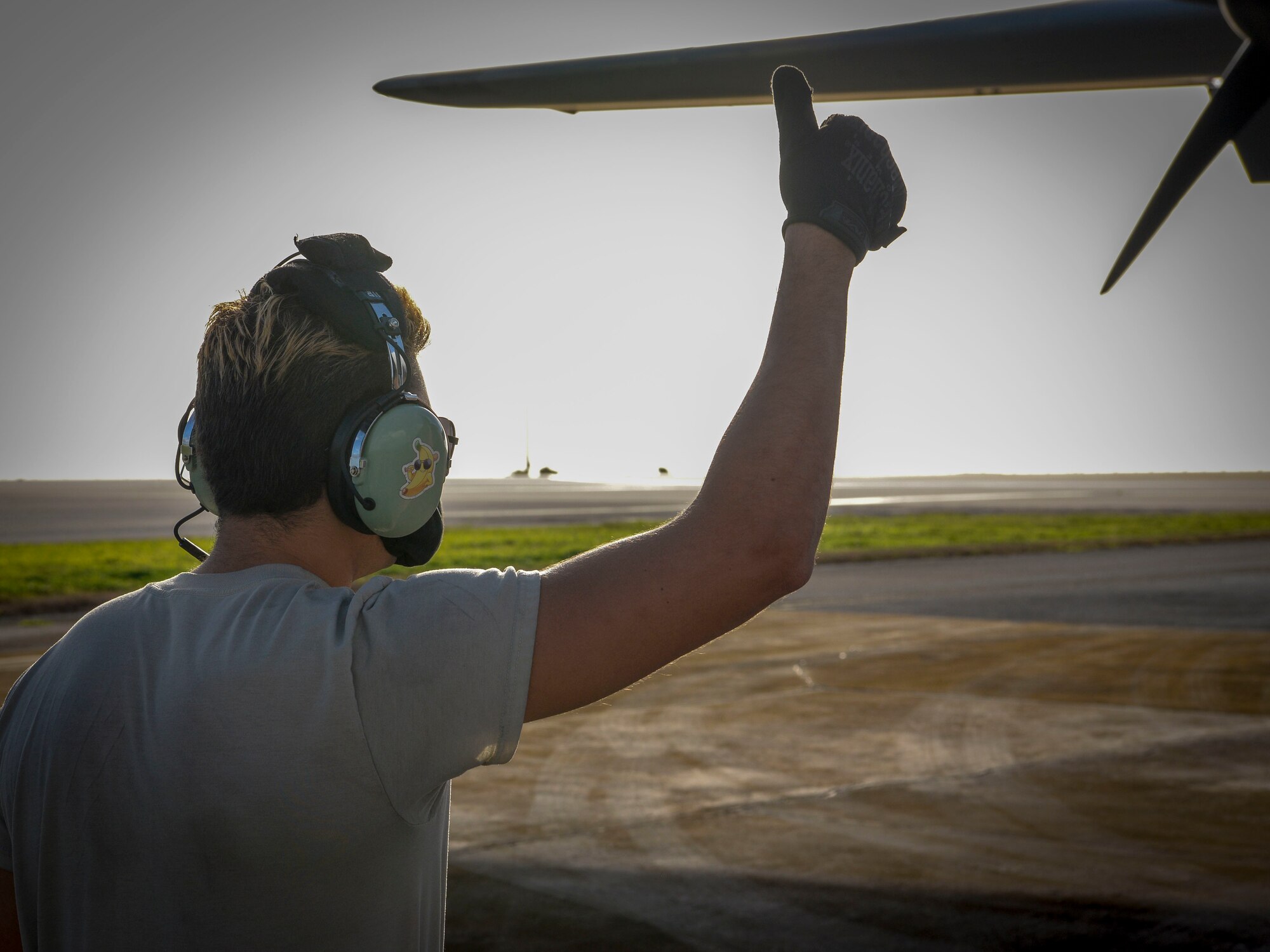 Senior Airman Stephen Yarbrough, 374th Aircraft Maintenance Squadron crew chief from Yokota Air Base, Japan, communicates with the rest of his team aboard a C-130J Super Hercules via radio during the refueling process at Operation Christmas Drop 2020 at Andersen Air Force Base, Guam, Dec. 9.