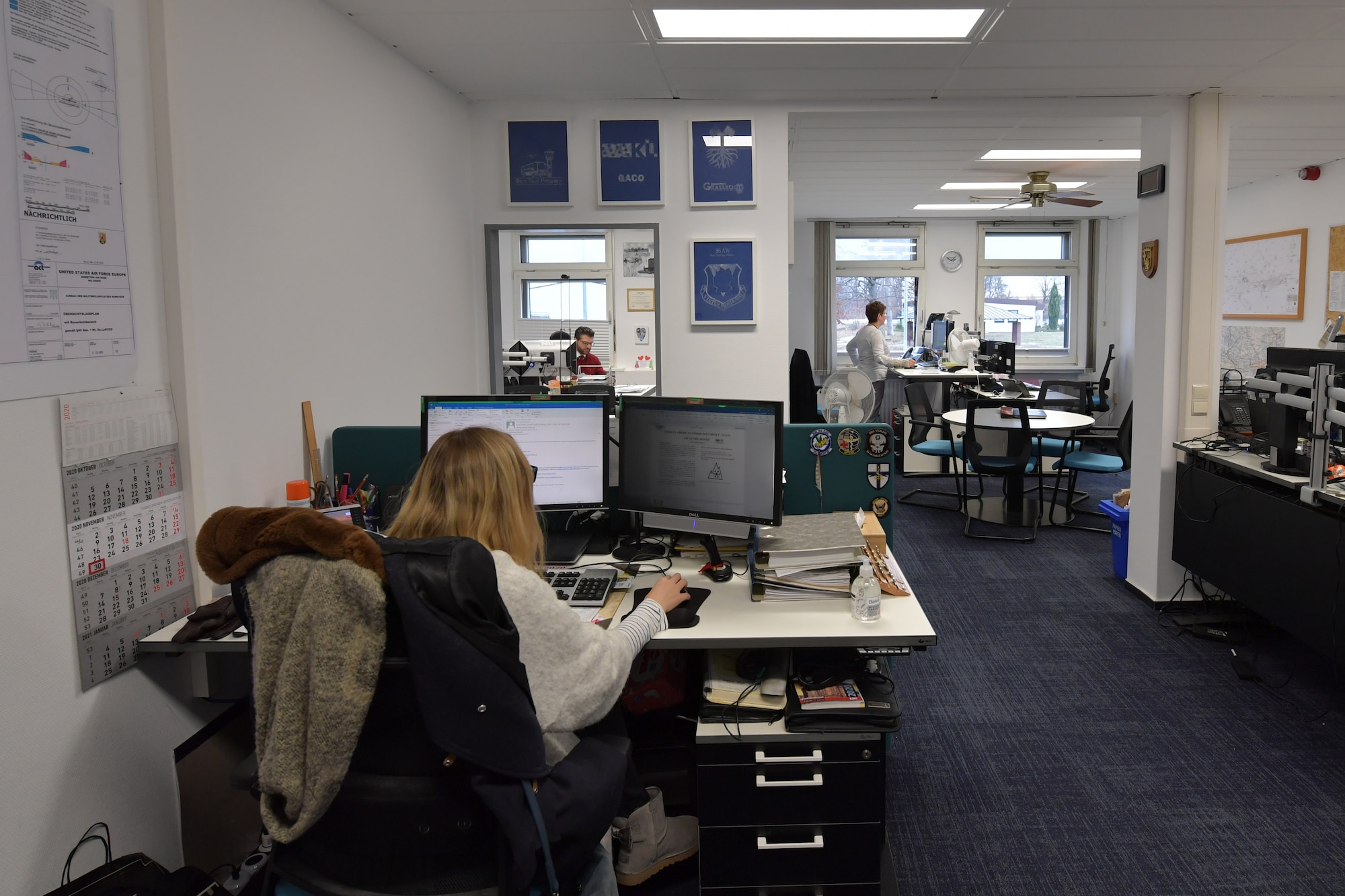 People working at desks in an office.