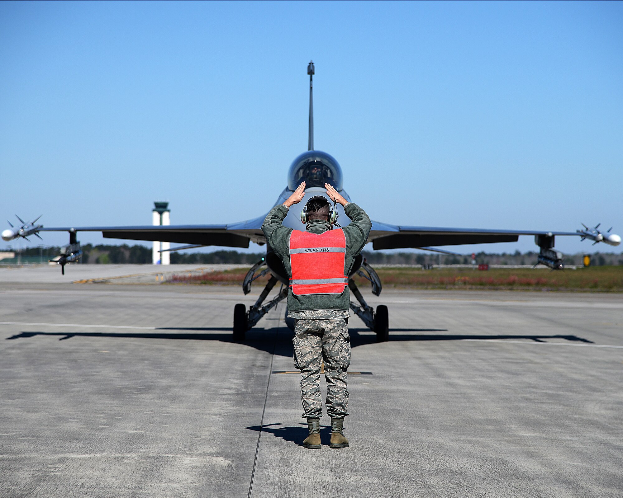 A photo of Tech. Sgt. Jeffrey J. Rain signaling an F-16 Fighting Falcon prior to launch.