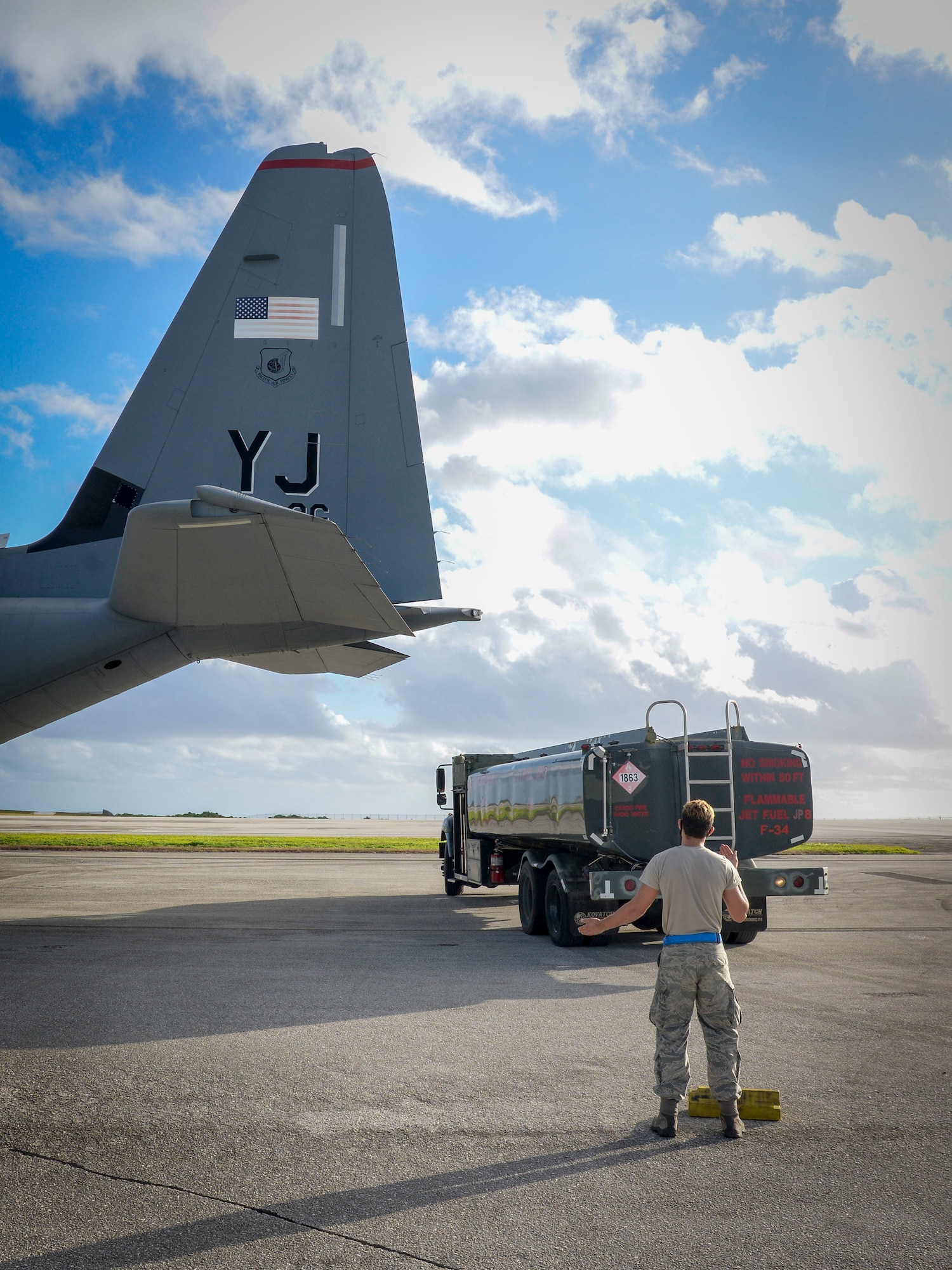 Senior Airman Stephen Yarbrough, 374th Aircraft Maintenance Squadron crew chief from Yokota Air Base, Japan, communicates with the rest of his team aboard a C-130J Super Hercules via radio during the refueling process at Operation Christmas Drop 2020 at Andersen Air Force Base, Guam, Dec. 9.