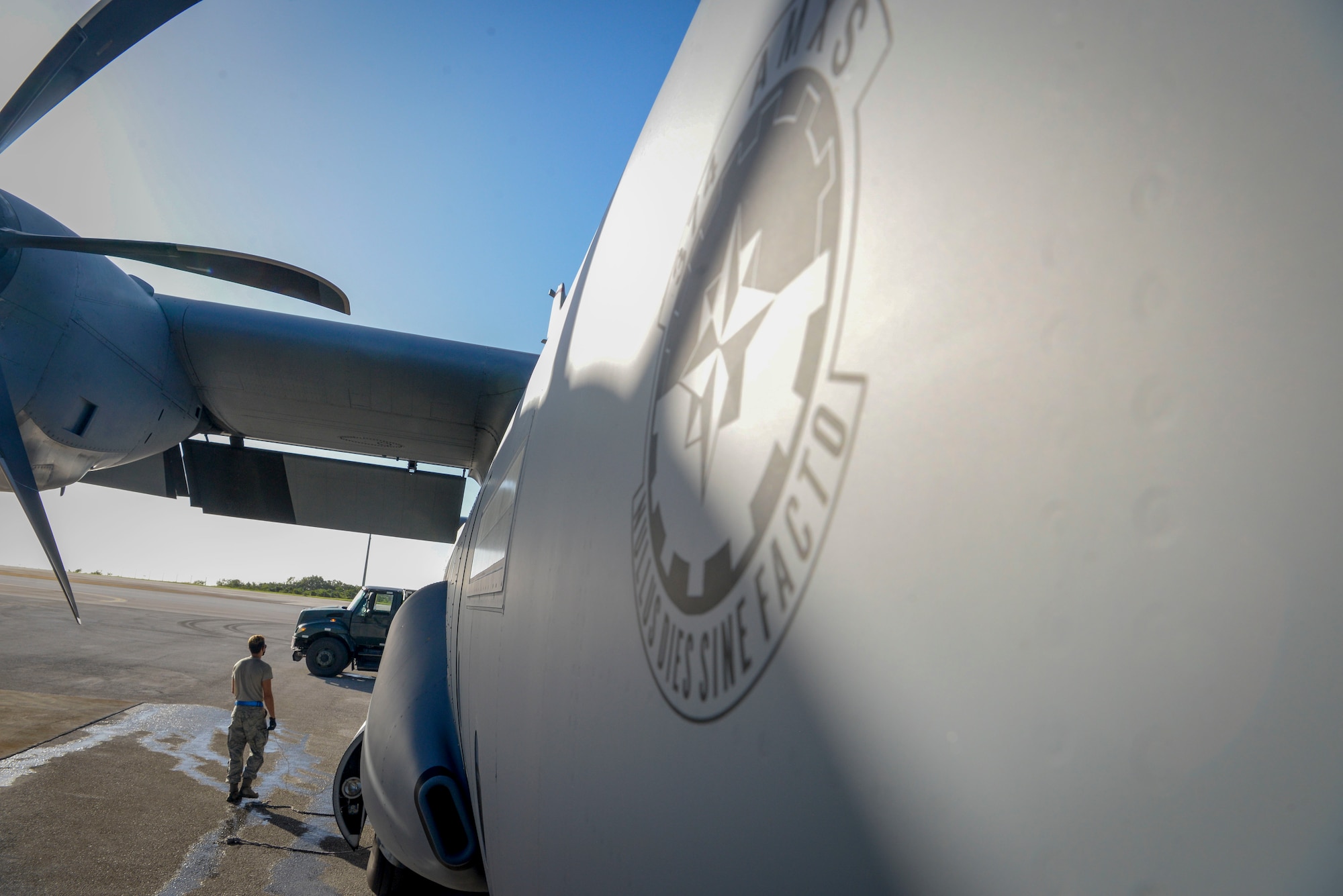 Senior Airman Stephen Yarbrough, 374th Aircraft Maintenance Squadron crew chief from Yokota Air Base, Japan, communicates with the rest of his team aboard a C-130J Super Hercules via radio during the refueling process at Operation Christmas Drop 2020 at Andersen Air Force Base, Guam, Dec. 9.