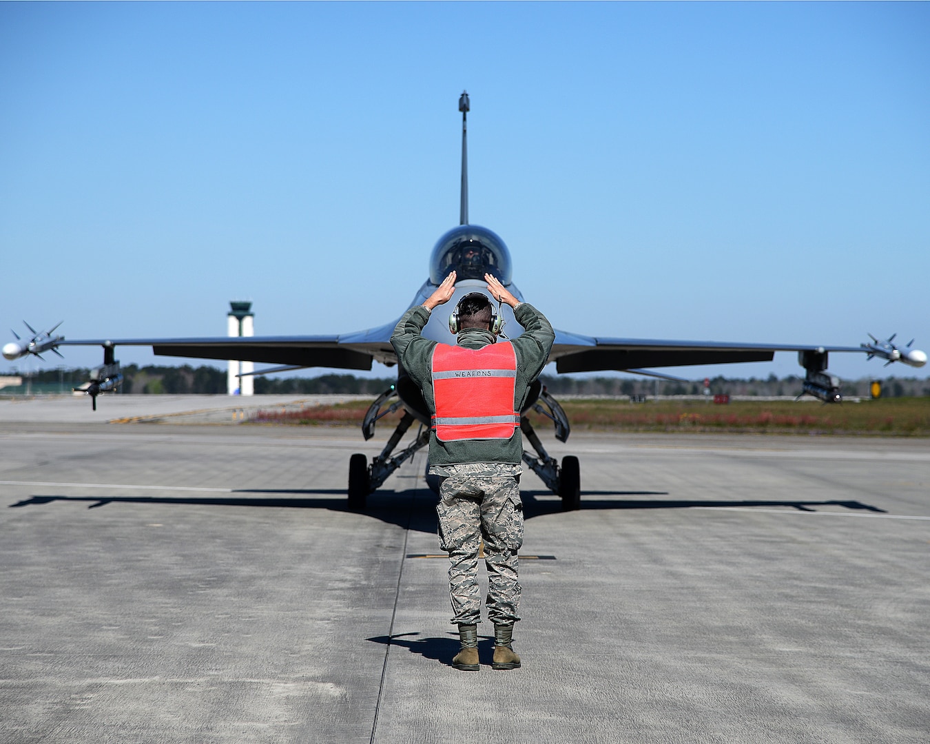 U.S. Air Force Tech. Sgt. Jeffrey J. Raine, an aircraft armament weapons loader with the New Jersey Air National Guard's 177th Fighter Wing, signals to an F-16C Fighting Falcon before launch at the Air Dominance Center in Savannah, Georgia, March 9, 2018. The 177th FW participated in an air-to-air training exercise to sharpen air combat capabilities and accomplish multiple training upgrades.