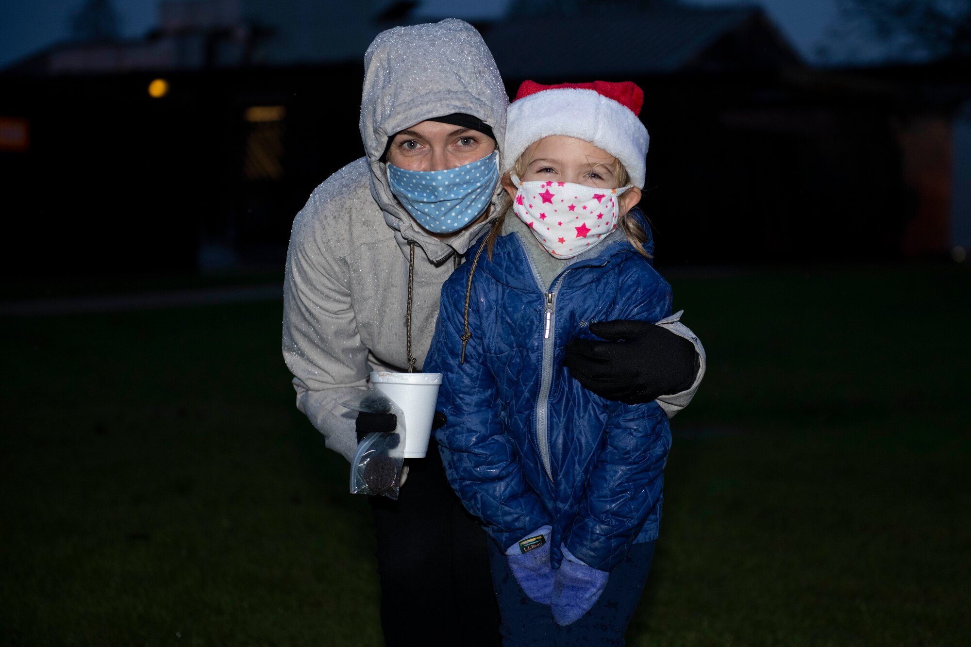 Members of the 501st Combat Support Wing community gather for a tree lighting ceremony at RAF Alconbury, England, Dec. 4, 2020. Col. Kurt Wendt, 501 CSW commander, and Chief Master Sgt. Daniel Keene, 501 CSW command chief, lit the tree with Santa Clause. (U.S. Air Force photo by Senior Airman Jennifer Zima)