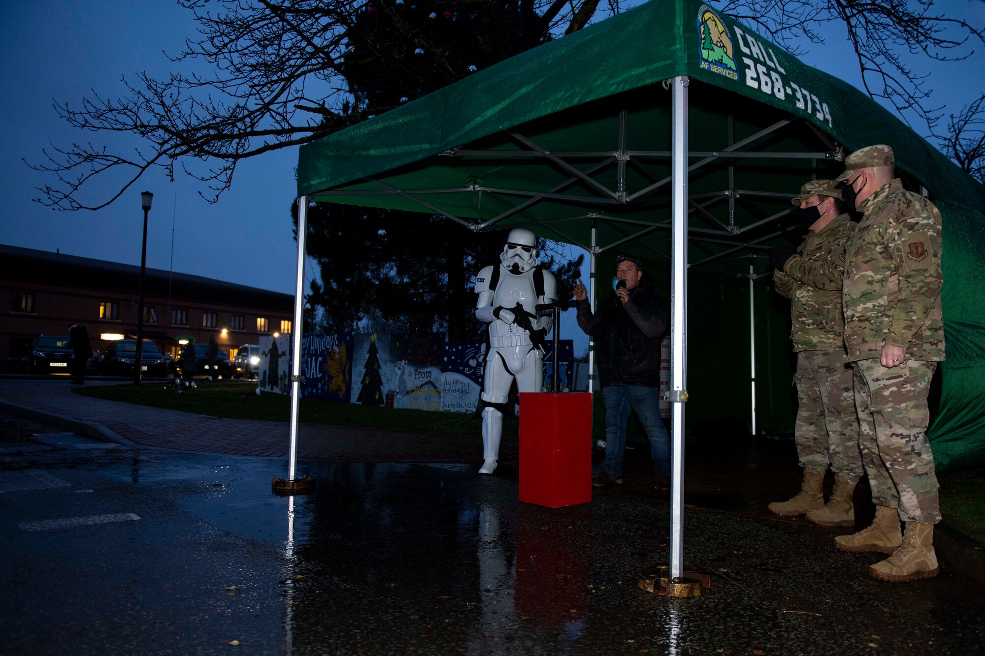 Members of the 501st Combat Support Wing community gather for a tree lighting ceremony at RAF Alconbury, England, Dec. 4, 2020. Col. Kurt Wendt, 501 CSW commander, and Chief Master Sgt. Daniel Keene, 501 CSW command chief, lit the tree with Santa Clause. (U.S. Air Force photo by Senior Airman Jennifer Zima)