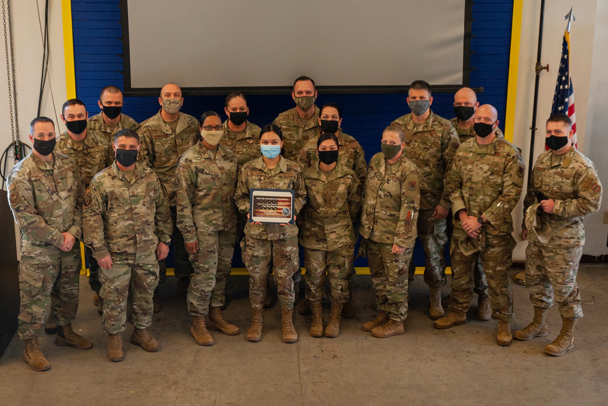 Photo of Airmen standing with an award