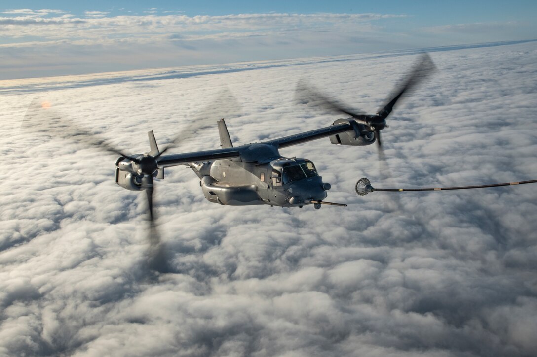 A military aircraft is refueled in midair.