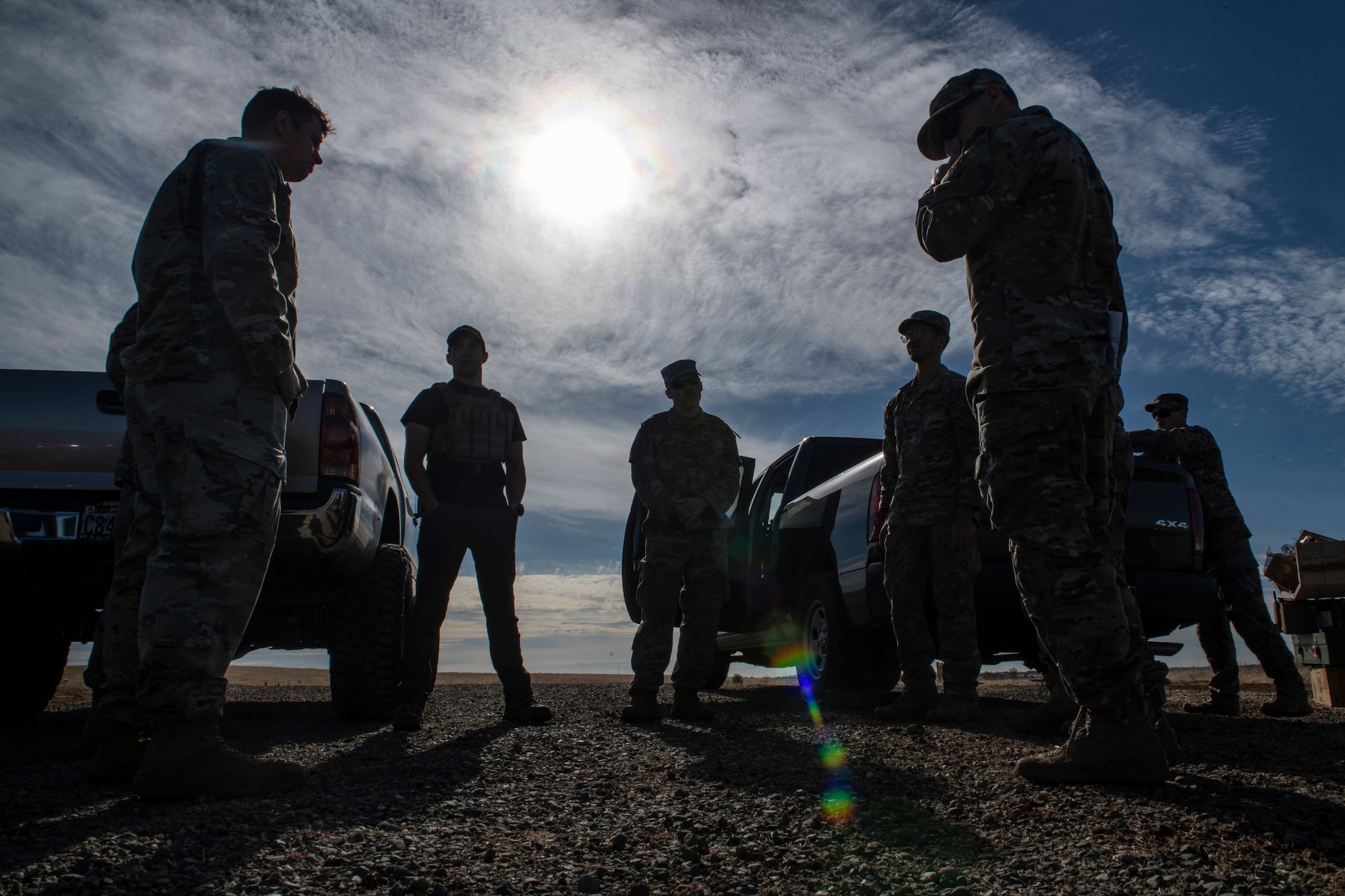 Beale Explosive Ordnance Disposal and Military Working Dog personnel discuss plans for collaborative training on Beale Air Force Base.