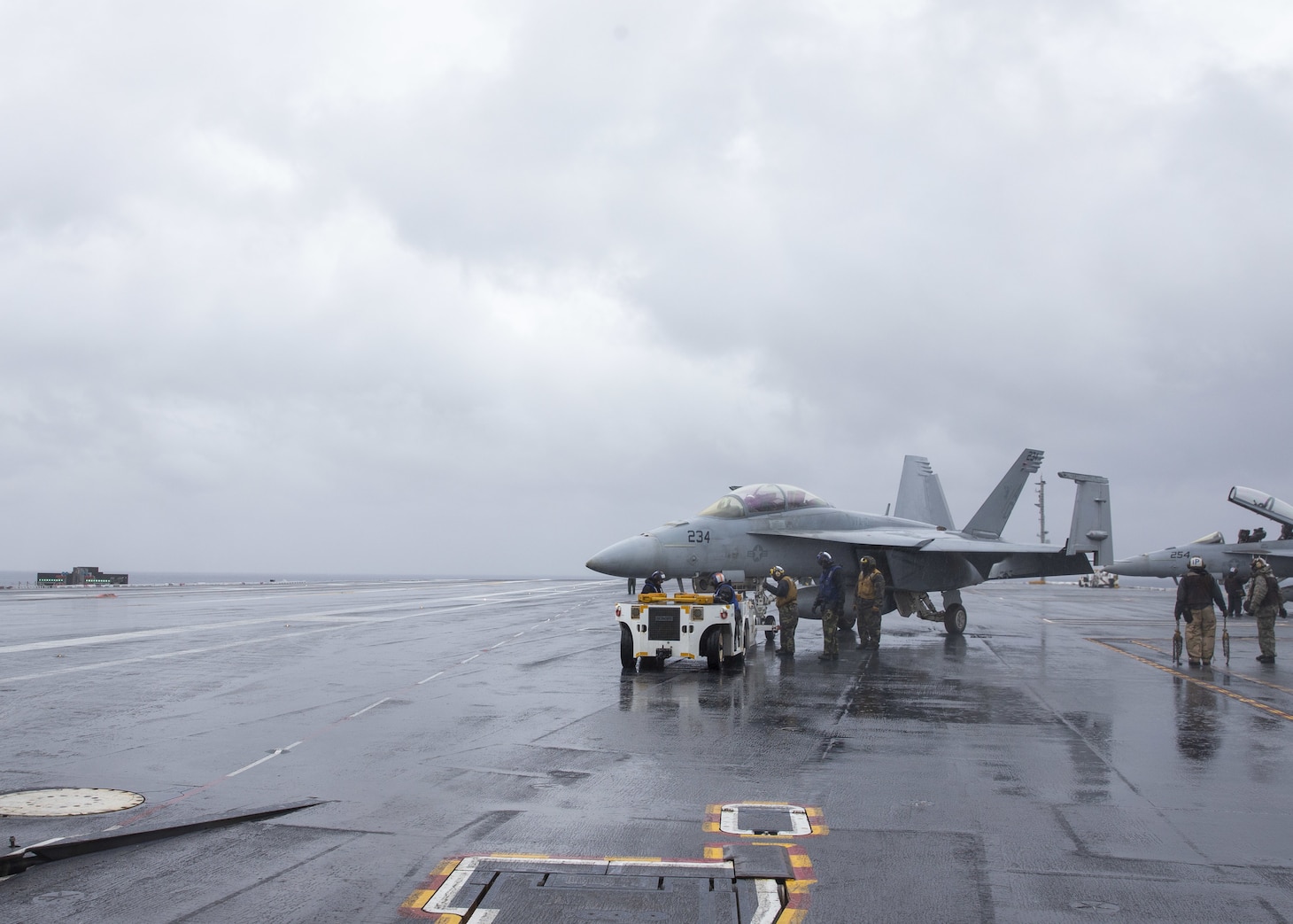 Sailors  maneuver an F/A-18F Super Hornet attached to the "Gladiators" of Strike Fighter Squadron (VFA) 106 on the flight deck of the aircraft carrier USS Gerald R. Ford (CVN 78) during flight operations Dec. 7, 2020.