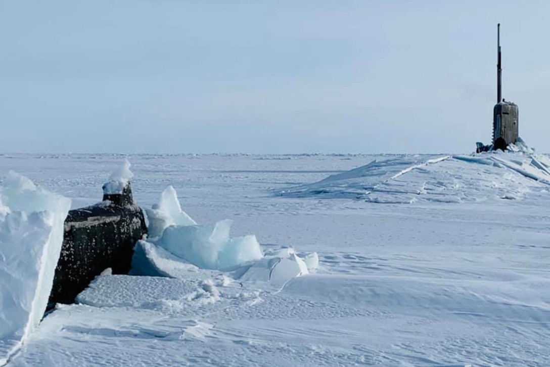 A submarine breaks through a sheet of ice as it comes to the surface.