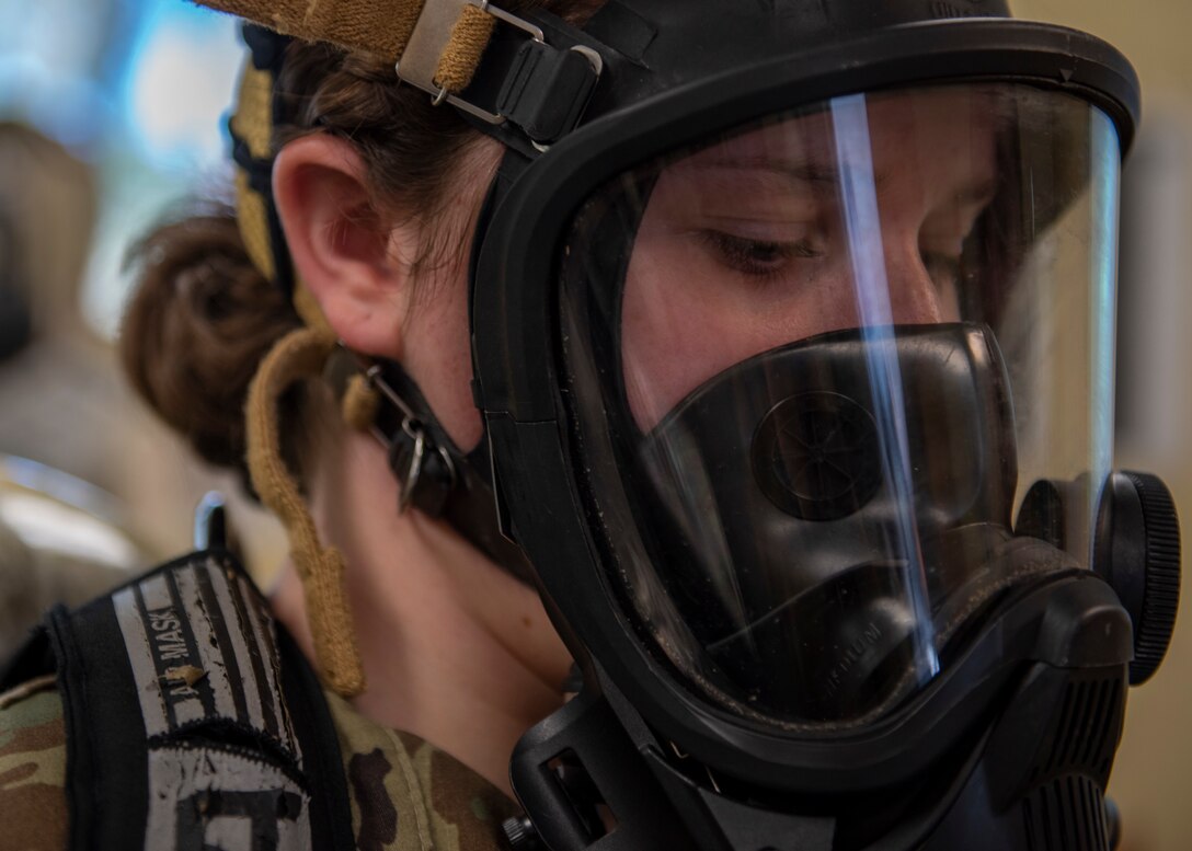 Airman 1st Class Delaney Thompson, 4th Civil Engineer Squadron emergency manager, dons a gas mask at Seymour Johnson Air Force Base, North Carolina, Nov. 19, 2020.