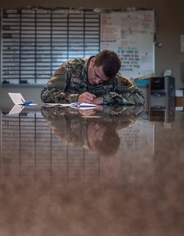 An Airman fills out a form to register as a bone marrow donor.